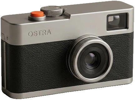 The Ostra 35 in titanium: natural grey top plate and lens ring, orange release button.